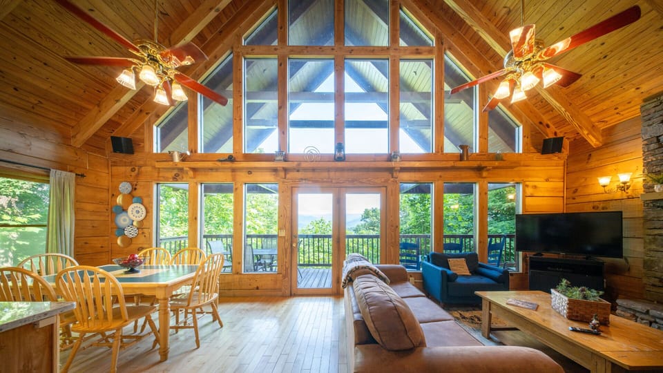 Soaring A-frame windows flood the living room with natural light and valley views.
