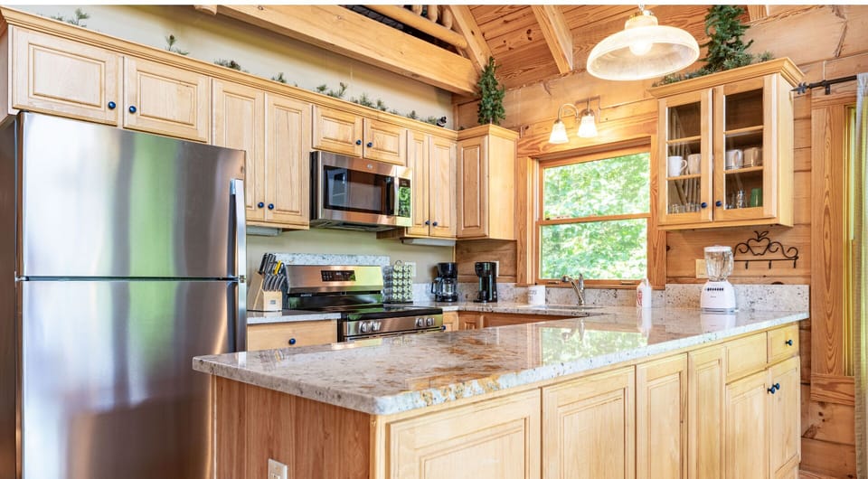 A well-equipped kitchen with stainless appliances and granite countertops.
