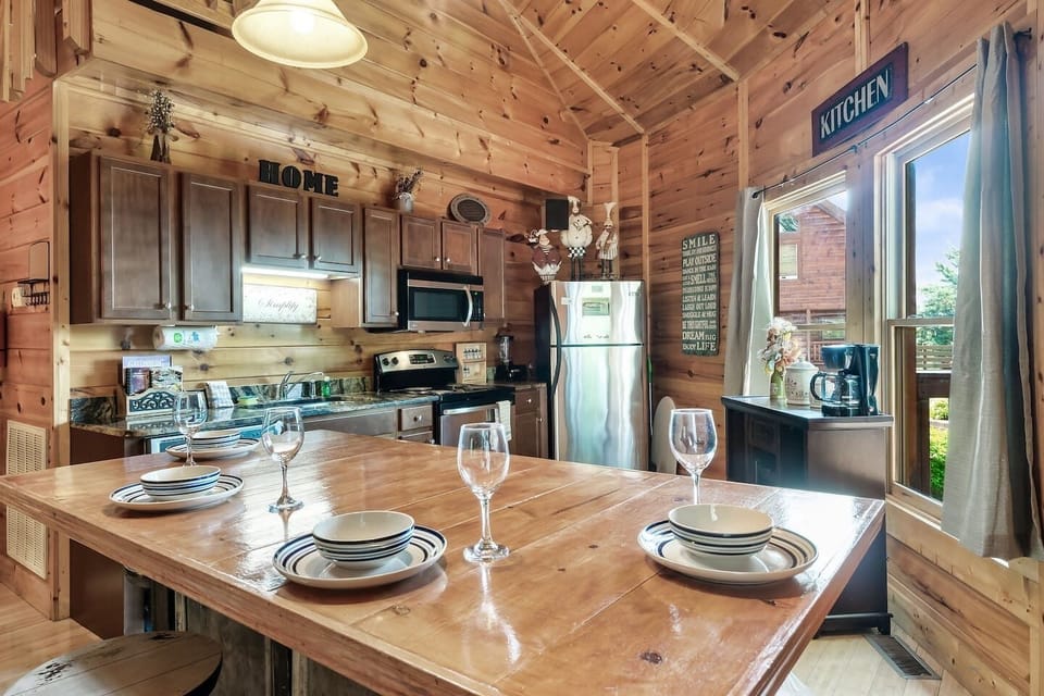Step into this cozy kitchen with a rustic table and a sleek refrigerator, the perfect setting for creating delicious meals! 

#Summer