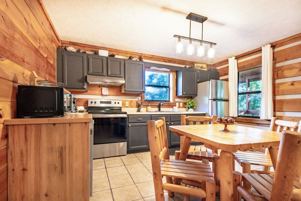 Wood cabinetry and stainless appliances equip this fully stocked kitchen.