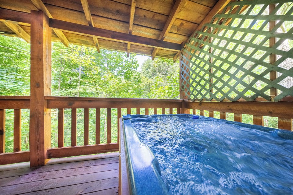  Relax and soak in the private hot tub on a covered deck surrounded by forest views.