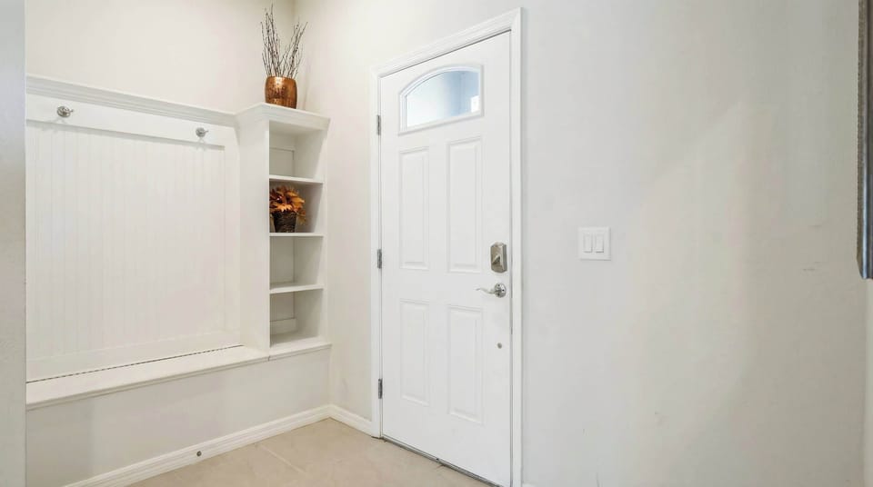 Inviting front entryway with built-in shelves and a cozy decorative touch.