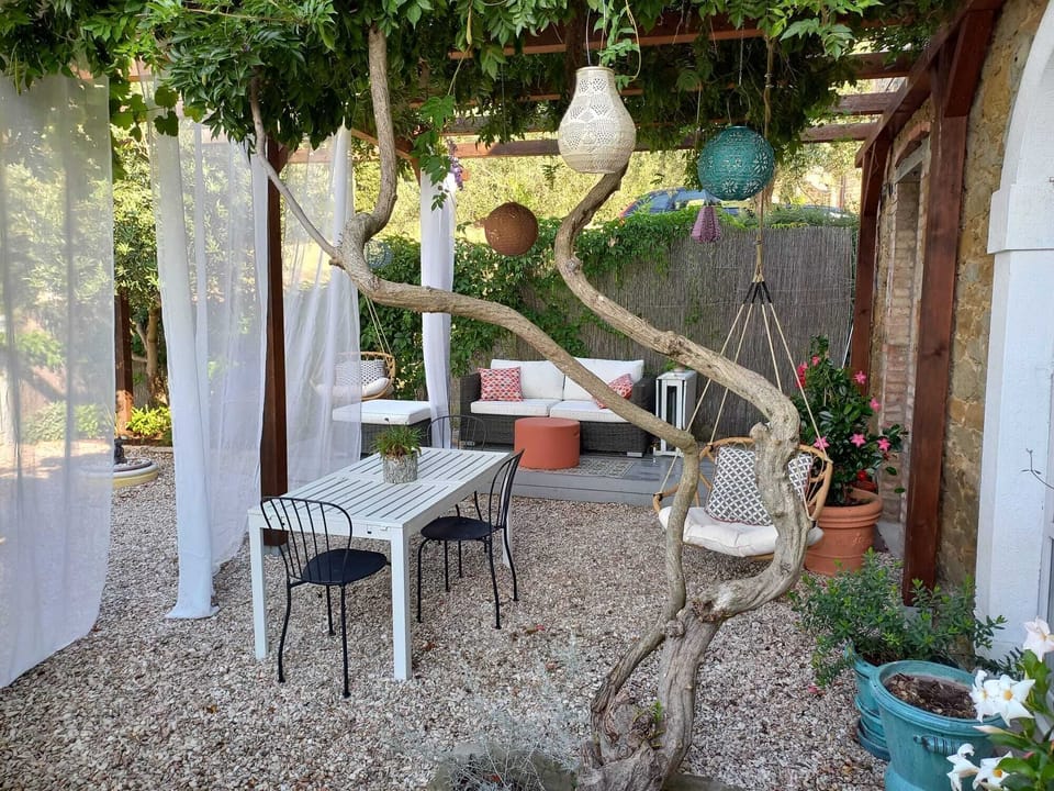Lounge seating, table for 6, two swinging chairs, solar globes and curtains