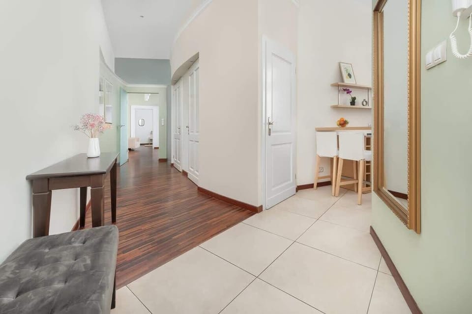  Stylish hallway with wooden flooring and modern lighting, creating a pleasant atmosphere from the moment you enter.