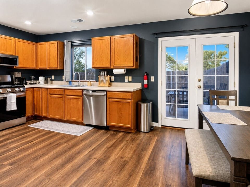Bright kitchen with French doors leading to the private fenced outdoor space.