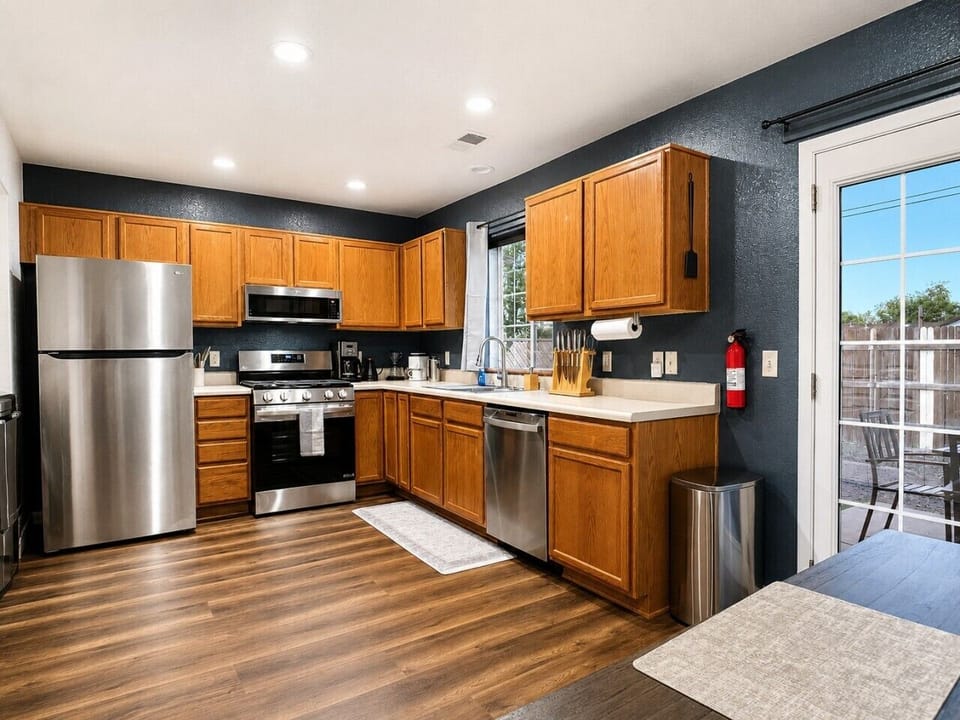 Fully stocked kitchen with stainless appliances, dishwasher, and plenty of space for group meals.