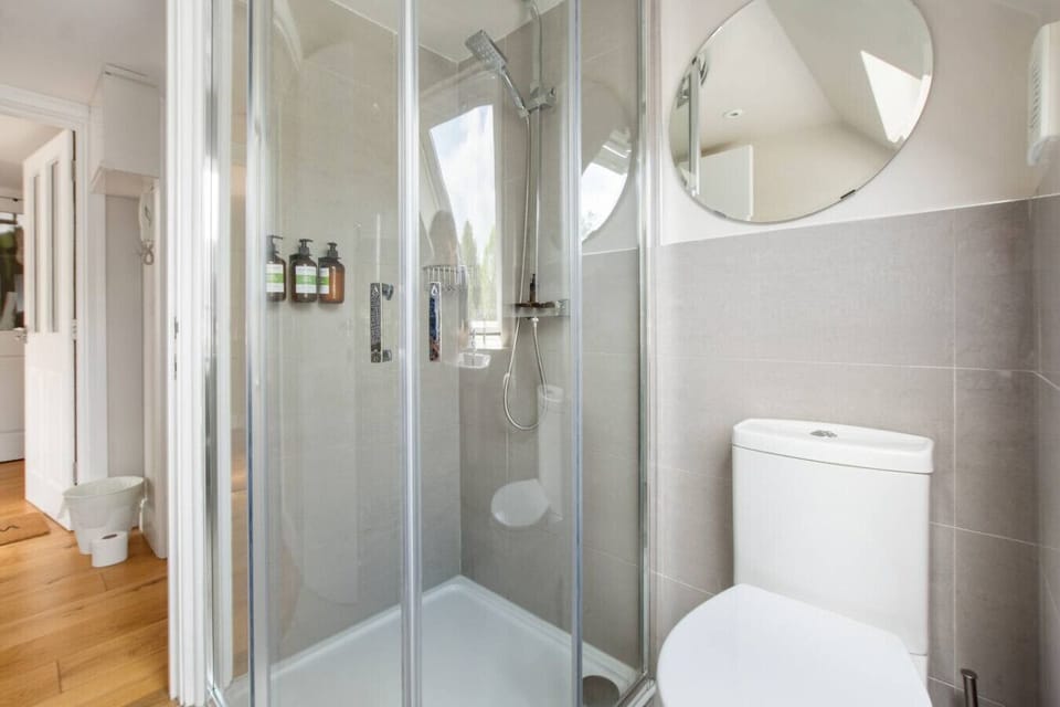 Bathroom with shower and complementary shampoo, conditioner and body wash