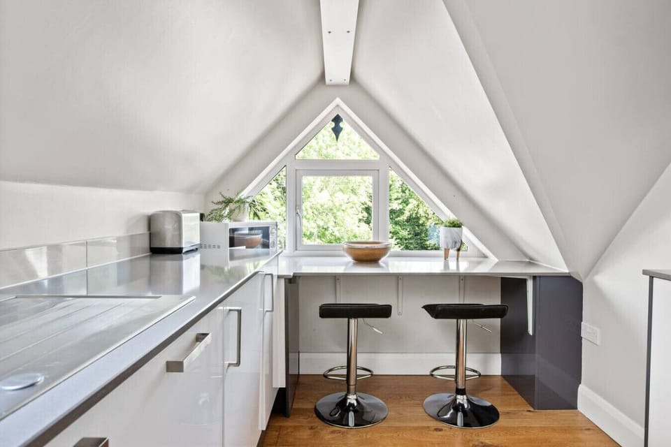 A small eating area at the end of the kitchen in front of the window
