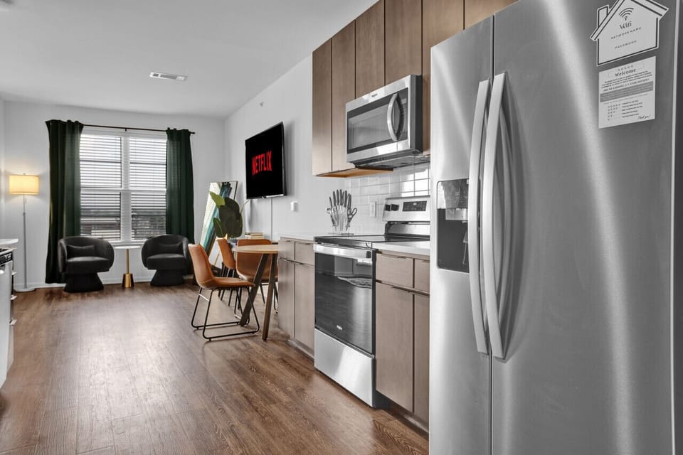 Modern kitchen with a sleek dining area, perfect for cooking, serving, and enjoying meals in style during your short-term rental stay