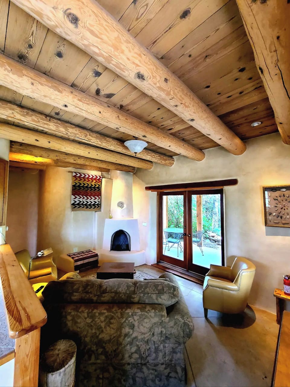 Living area and doors to patio with seating