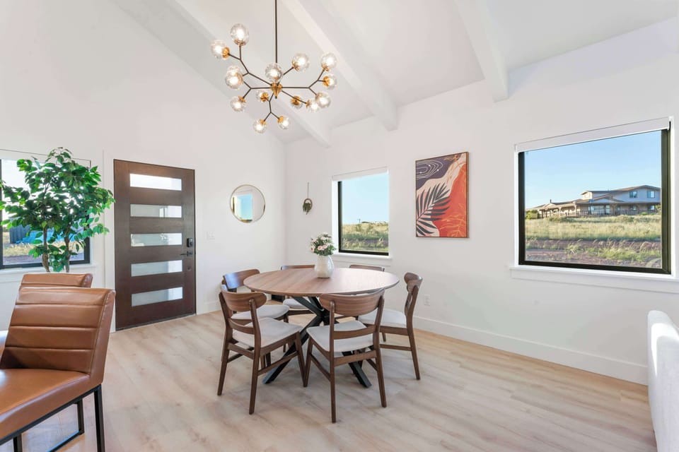 Dining area, with ample seating for 6 at the dining table and additional seating for 2 more at the kitchen island