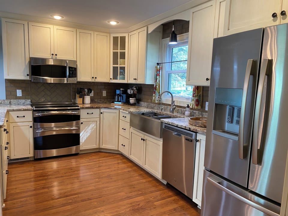 Stocked kitchen with a crock pot, air fryer, and cleaning supplies.