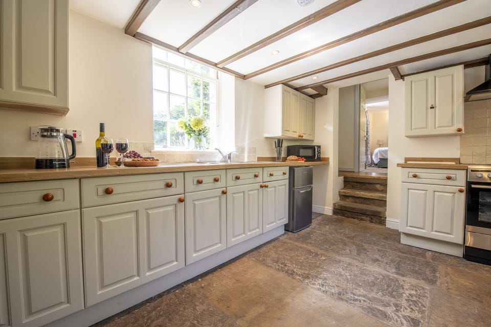 Lower ground floor: Kitchen featuring flagged stone floor and exposed beams