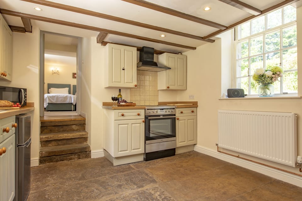 Lower ground floor: Kitchen with steps leading up to bedroom two and the en-suite shower room