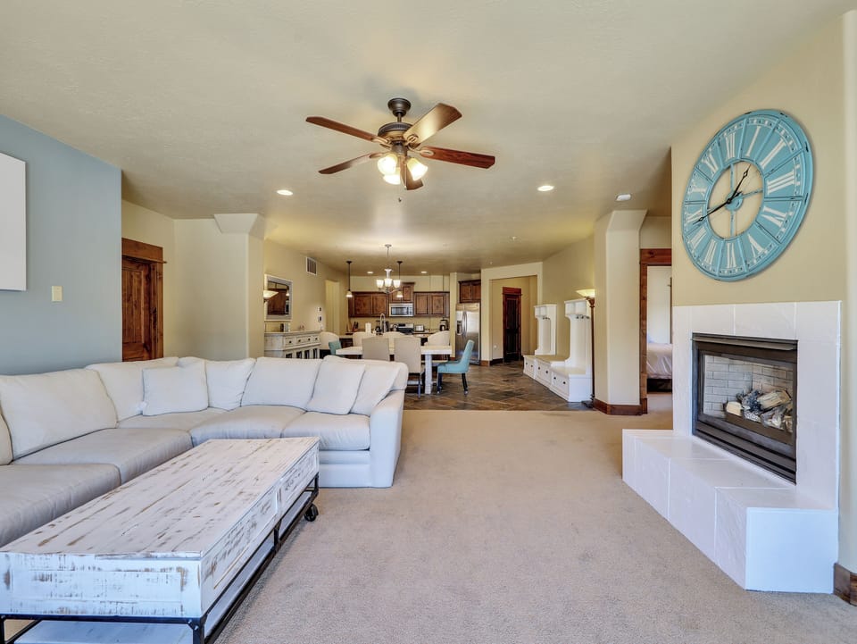 View of Living Room Gas Fireplace, Private Balcony Access, Ceiling Fan, 56" Smart TV with Roku, Sideboard
