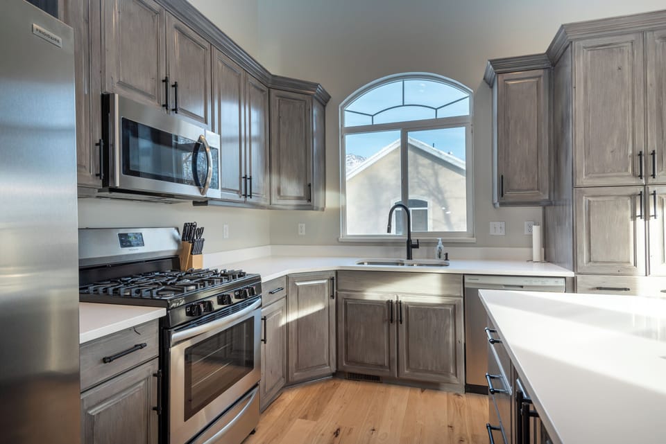 Gourmet kitchen with quartz countertops, stainless appliances and a gas cooktop