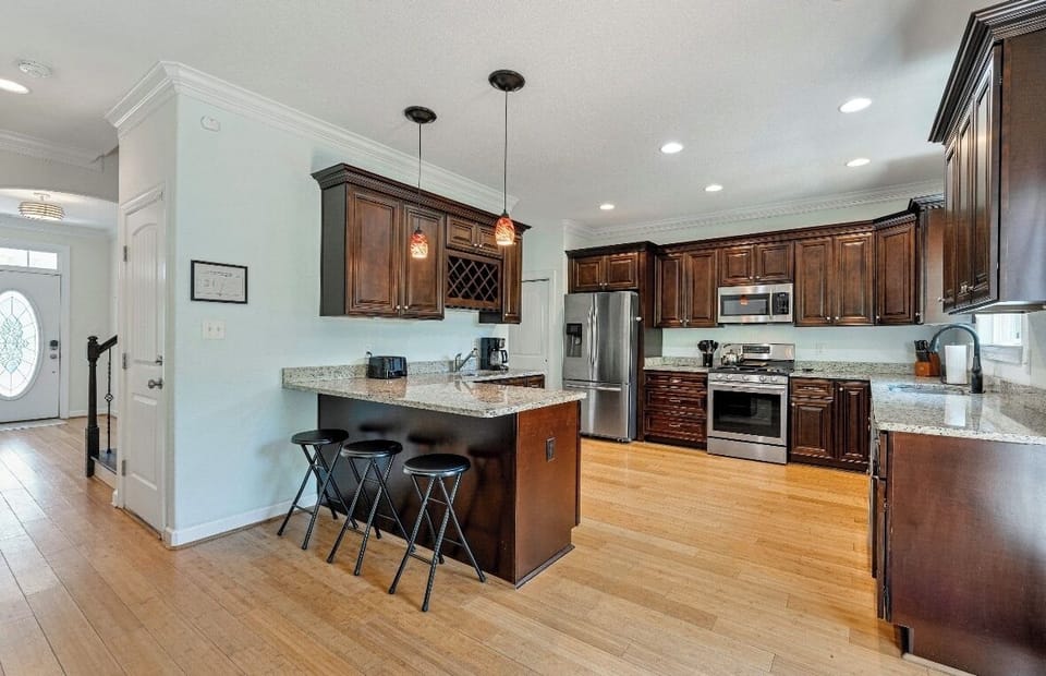 Spacious kitchen with bar stools for extra seating at the island. 