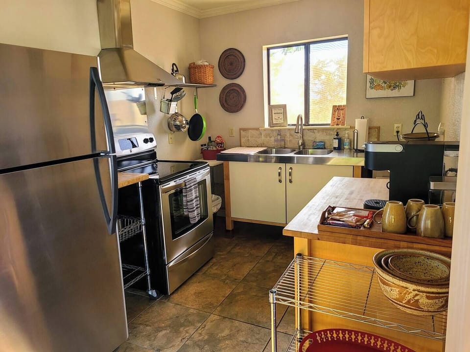 Kitchen has full-size appliances and is well stocked with Keurig coffee maker.