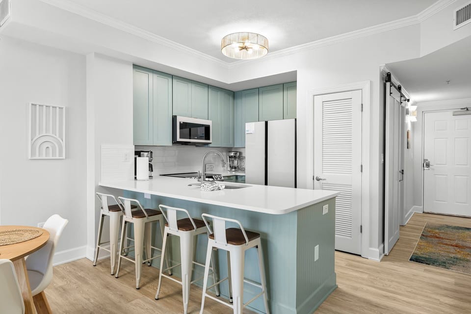 Fully equipped kitchen with quartz countertops and stainless appliances for effortless vacation dining