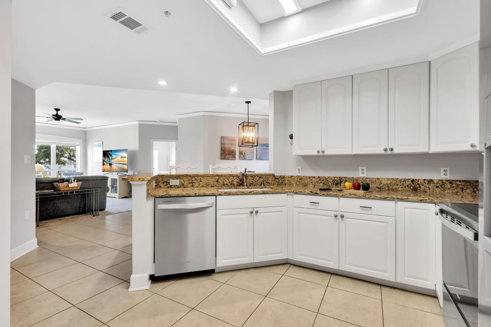 A fully-equipped kitchen with granite countertops has everything necessary to cook and serve basic meals