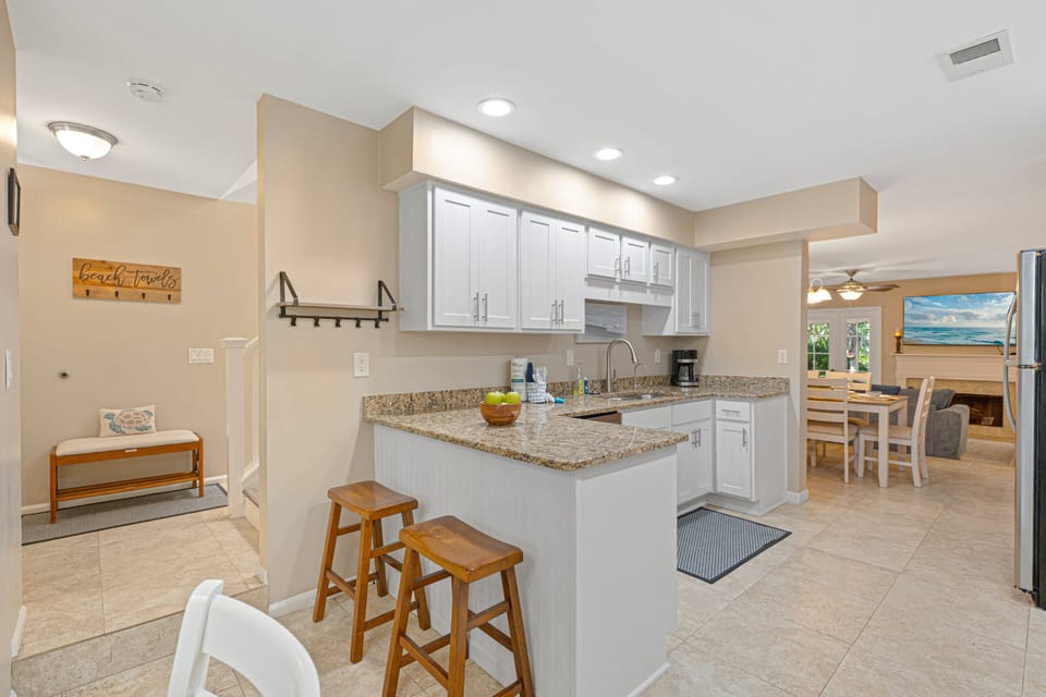 Spacious and inviting kitchen with ample counter seating.