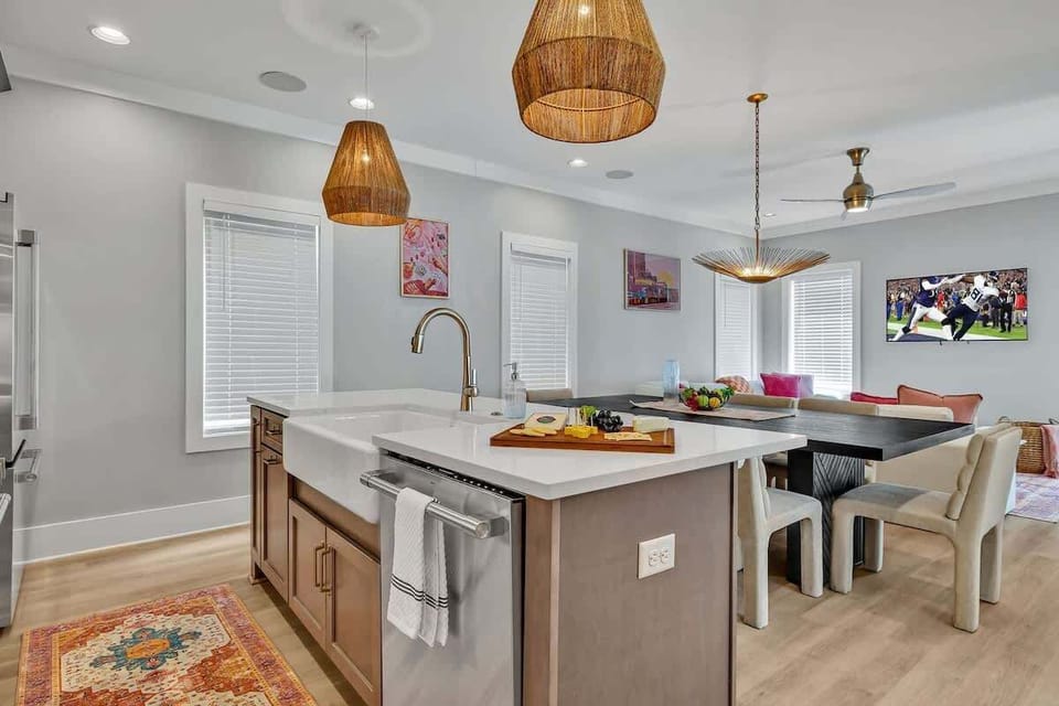 Unit 1 - 2nd Floor: Fully equipped kitchen stocked with all culinary essentials featuring stainless-steel appliances and a kitchen island offering ample counter space and bar seating.