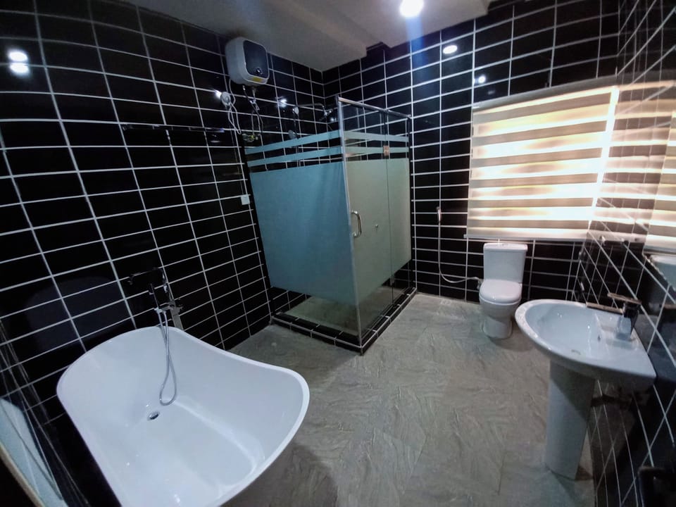 Shower, rainfall showerhead, slippers, towels