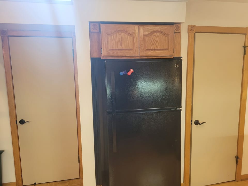 BATHROOMS:  Another fun design feature is that the home has 2 bathrooms right next to each other on the main floor.  The entrance to each bathroom is on either side of the kitchen refrigerator.