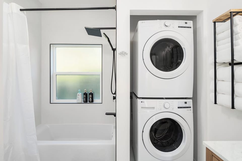 Bright and functional, this bathroom integrates laundry facilities without sacrificing style or space, making it a perfect example of modern home efficiency.