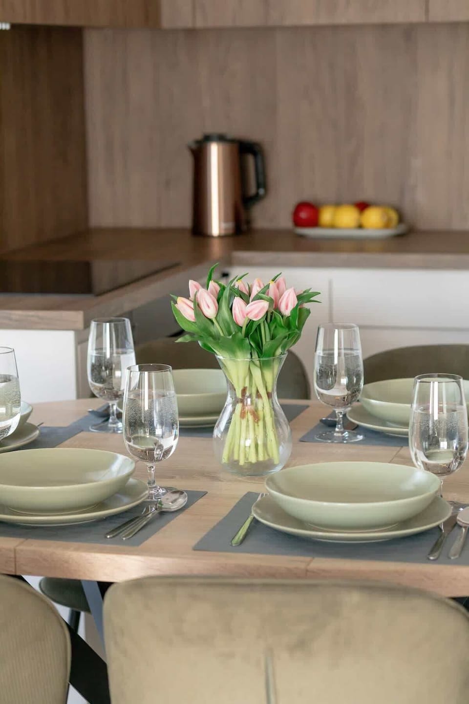A close -up for dinning table with dishes and flowers.