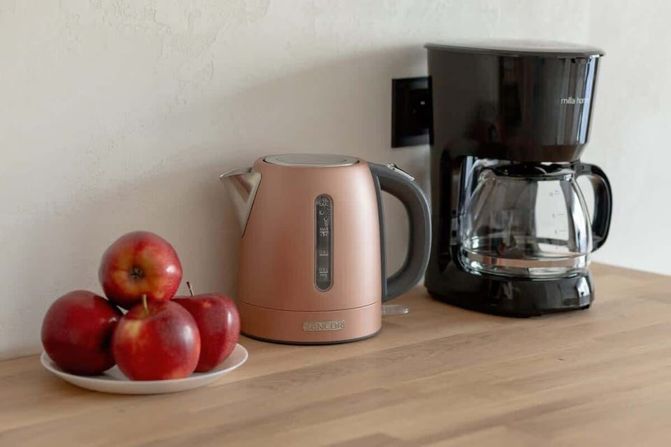 Coffee maker and electric kettle, complementing the kitchen space, perfect for making morning coffee and tea.