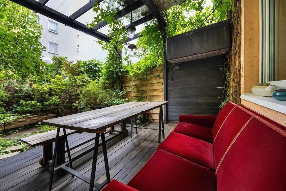 A spacious terrace with a green view and comfy seating offers ideal conditions for outdoor relaxation.