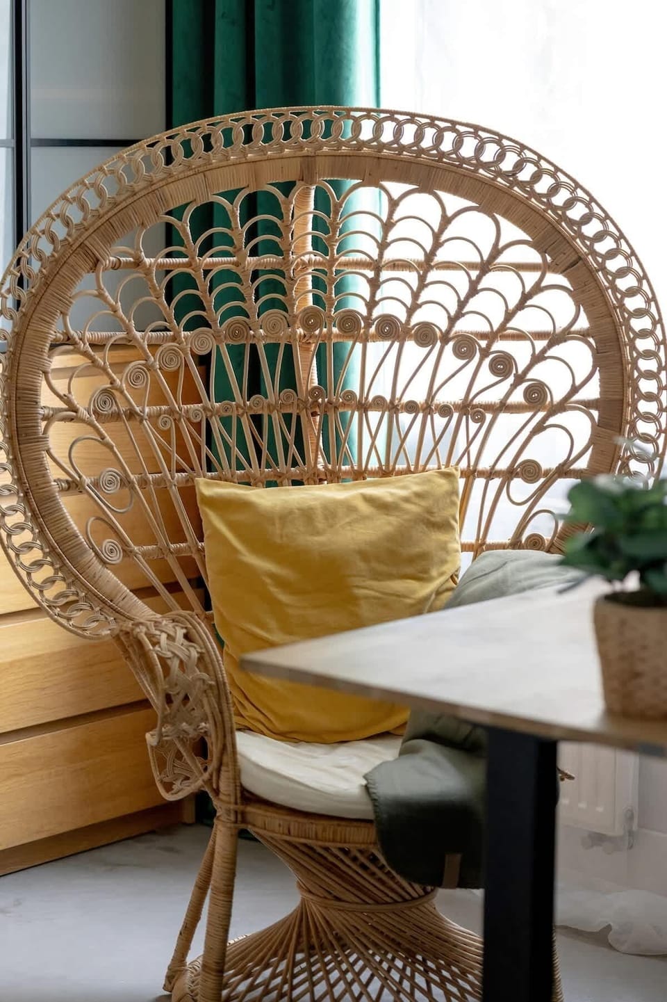 A wicker chair in a natural style adds charm and a relaxing vibe to the apartment interior.