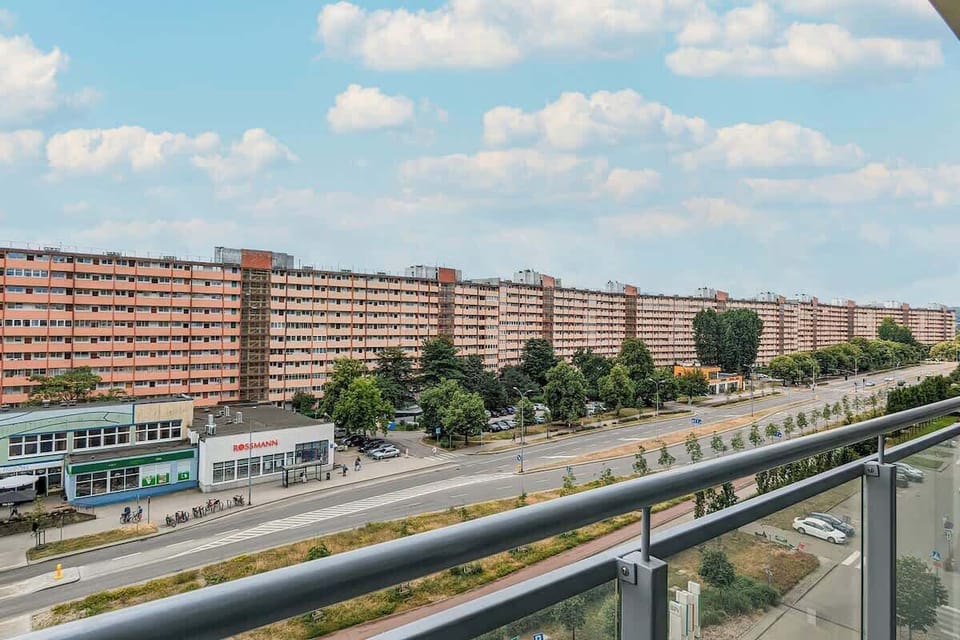 The view from the balcony reveals a vibrant area and the modern infrastructure of Gdańsk.