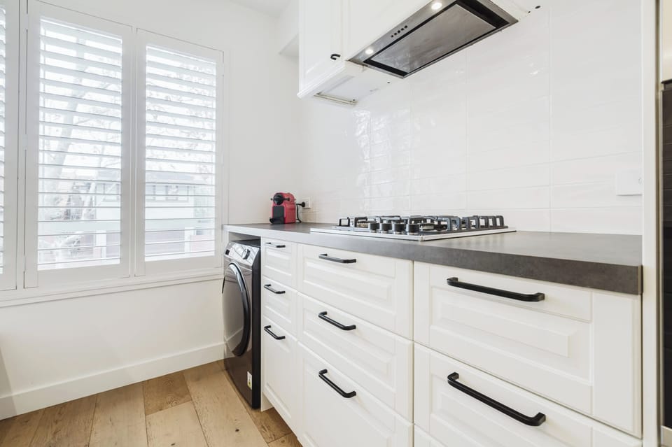 Galley-style kitchen with all the mod cons you'd expect to find as well as underbench Laundry facilities - washing machine and dryer.