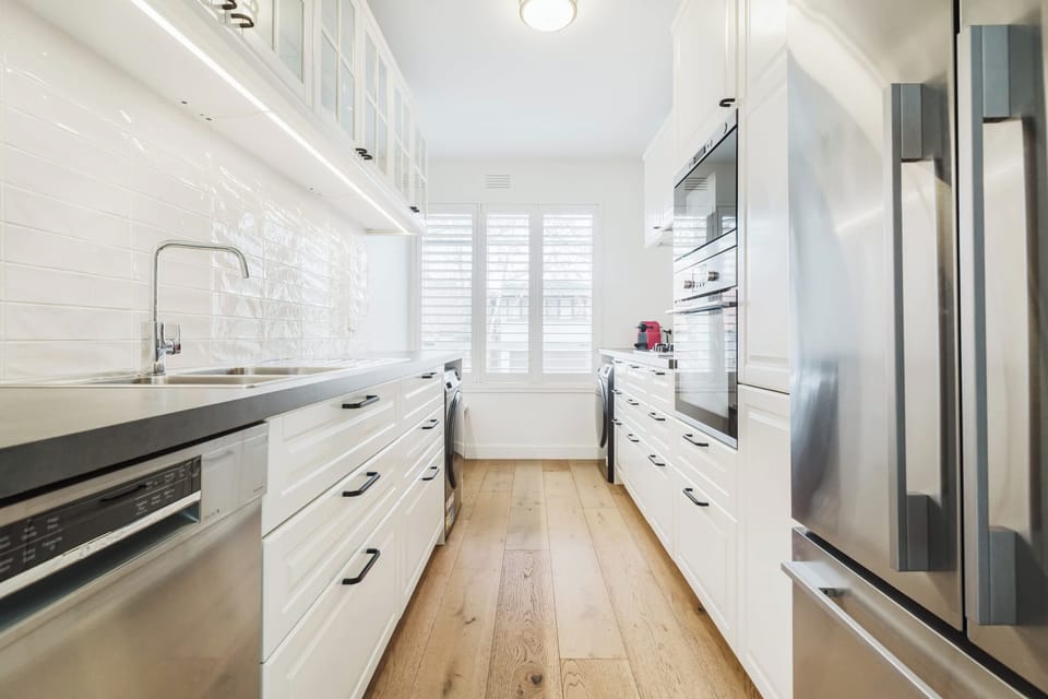 Galley-style kitchen with all the mod cons you'd expect to find as well as underbench Laundry facilities - washing machine and dryer.