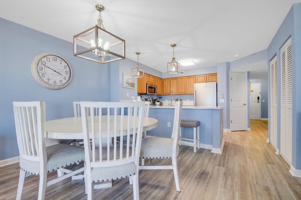 Enjoy meals in this bright, open space where your dining area flows into a fully-equipped kitchen, perfect for cooking and entertaining.