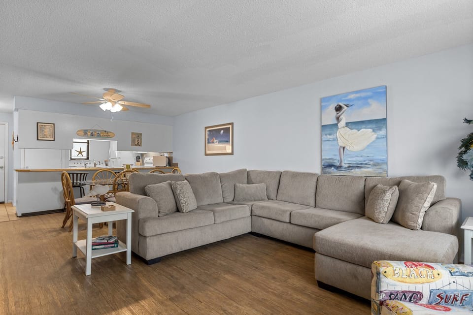 Relax on your spacious sectional while ocean breezes flow through this bright, beach-themed living area.