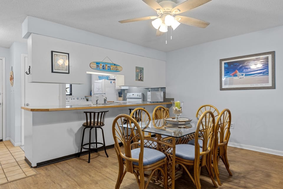 Gather around your glass dining table for six, with an open kitchen nearby for easy meal prep and serving.