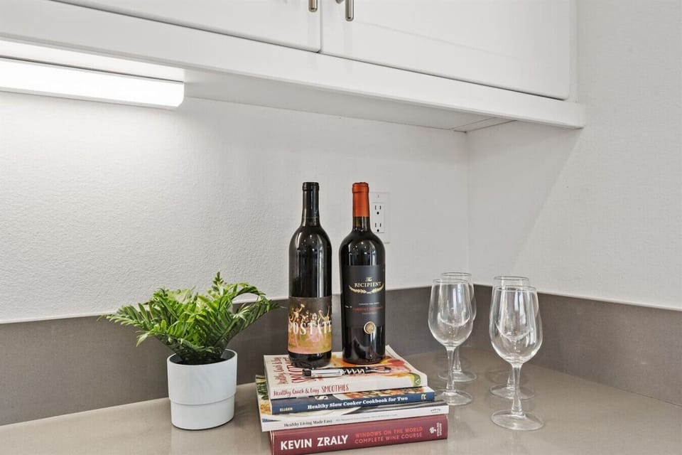 Charming Kitchen Nook: Savor wine and laughter with books and elegant glassware at your fingertips!