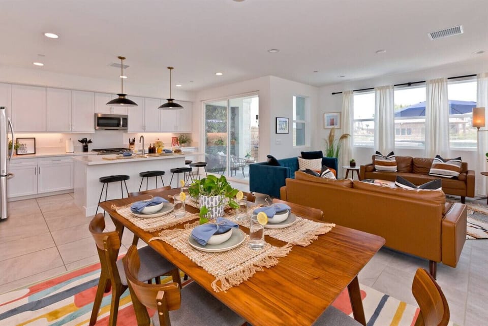 The mid-century modern chairs add a touch of retro charm, perfect for sharing delicious meals and laughter with loved ones.