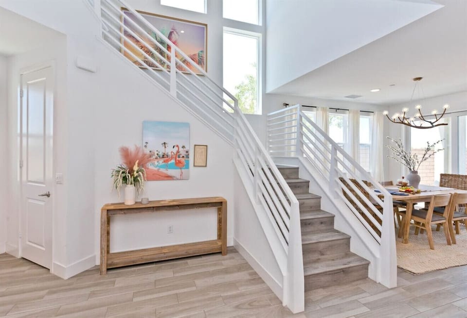 This sleek staircase leads to cozy bedrooms and private bathrooms upstairs, offering a peaceful escape after a day of exploring.