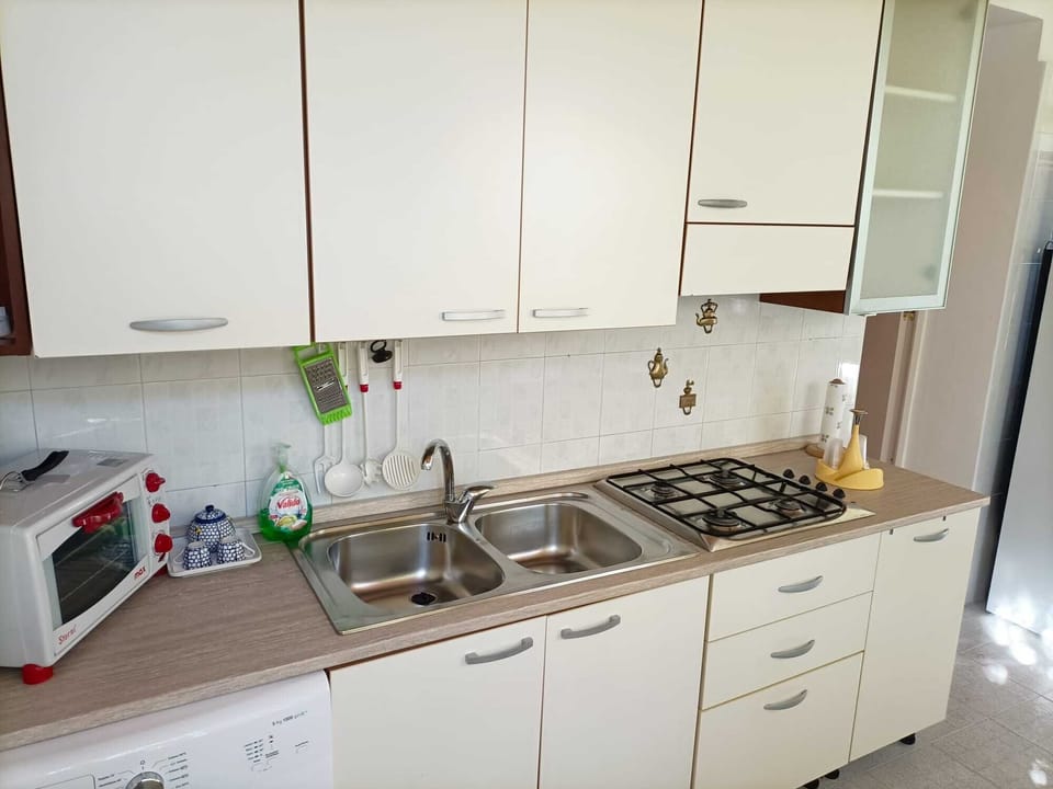 Comfort Apartment | Private kitchen | Full-size fridge, stovetop, electric kettle, cookware/dishes/utensils