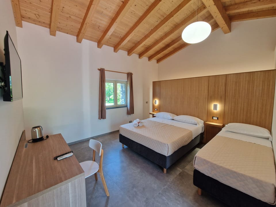 Triple Room, Garden View | Desk, free cribs/infant beds, free WiFi, bed sheets