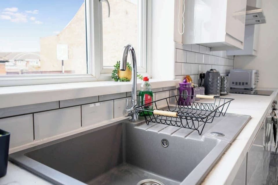 Kitchen equipped with all essentials, including a oven, fridge and full cookware set.