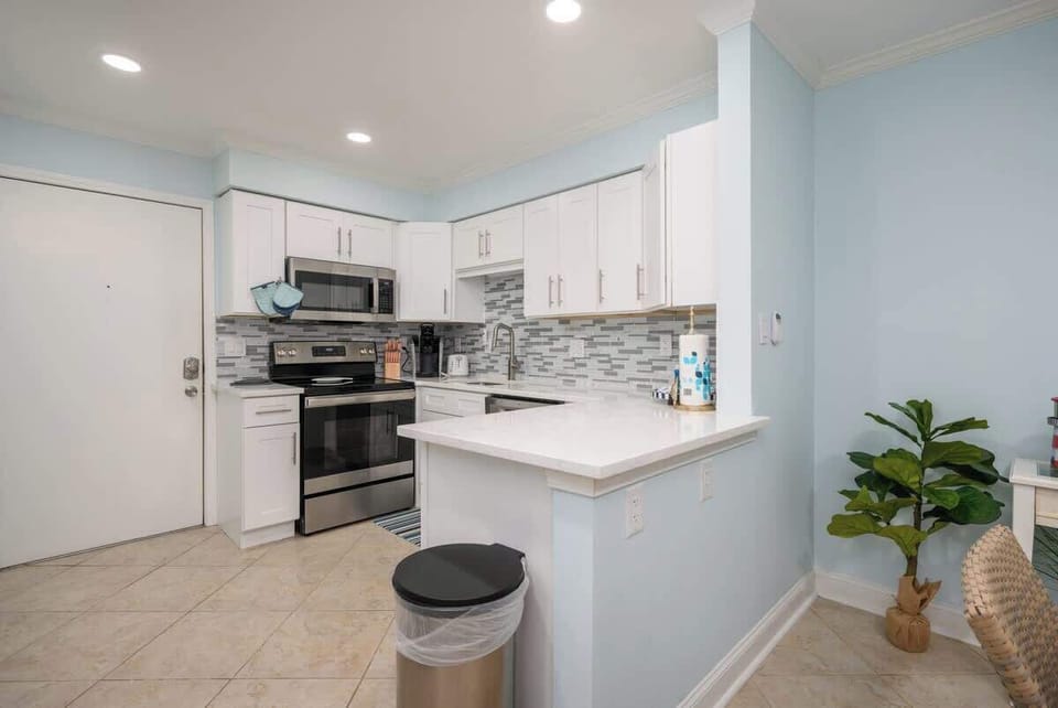 Open-concept kitchen features modern stainless steel appliances. 