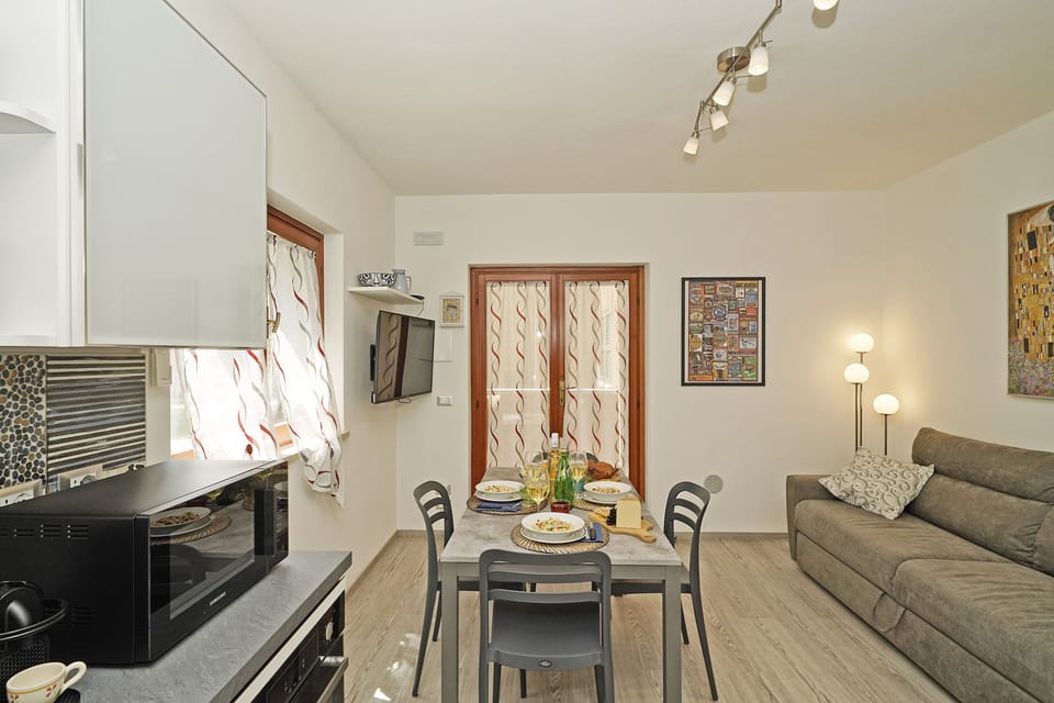 Apartment, Balcony, Garden View | Living area | 32-inch flat-screen TV with cable channels