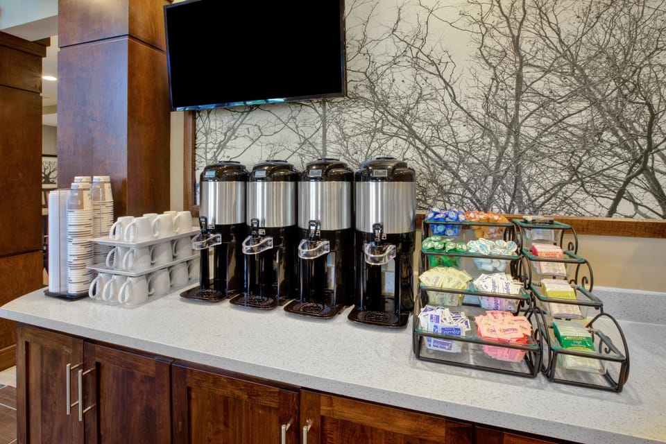 Self-serve coffee and beverage station with hot drink options.