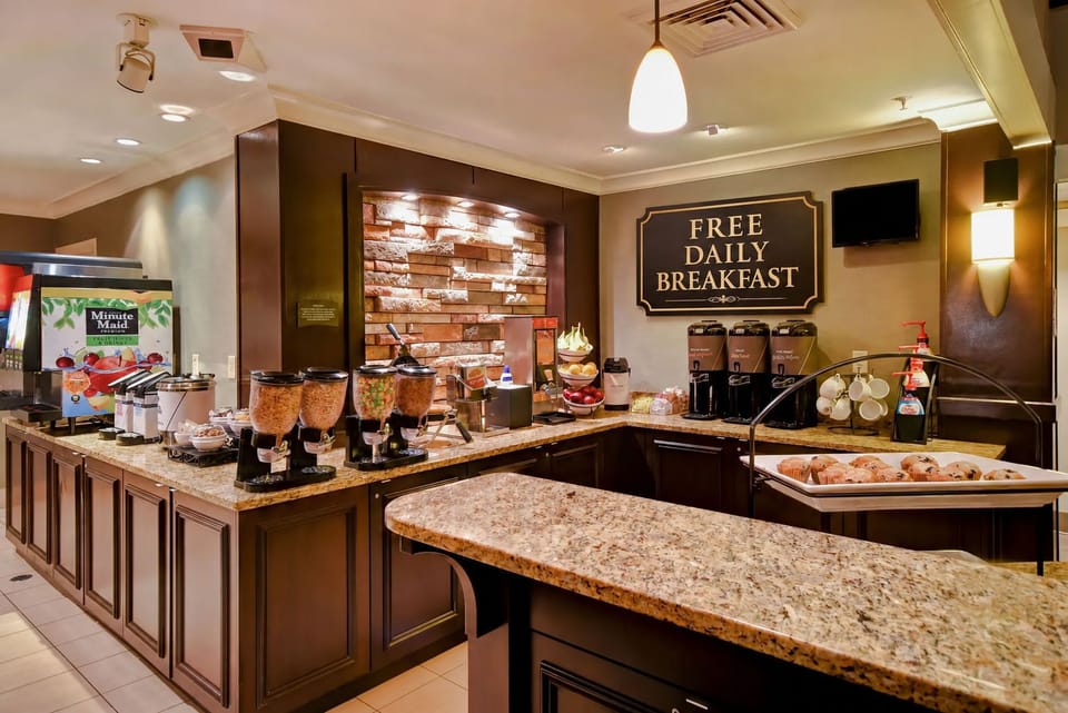 Breakfast area with cereals, pastries, and beverages