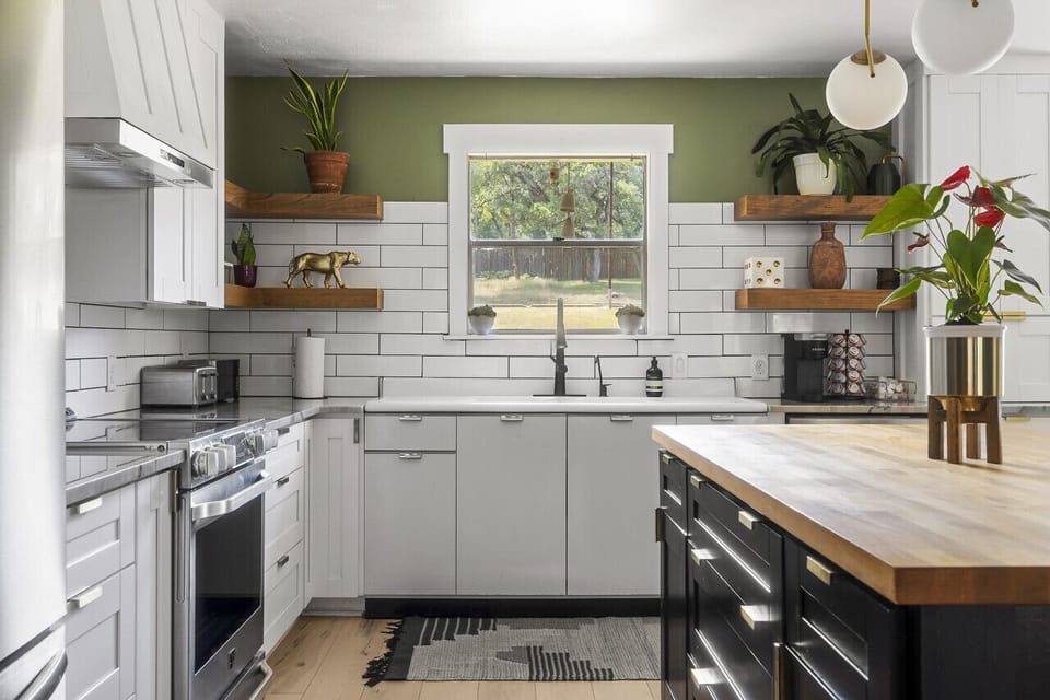 Modern kitchen with electric range, farmhouse sink, and open shelving